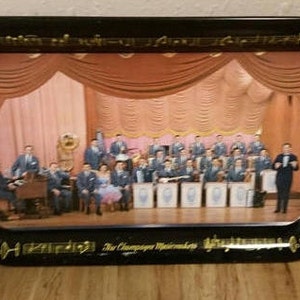 May include: A black metal tray with a gold border and musical notes. The tray features a vintage photograph of a band called "The Champagne Musicmakers" performing on stage.
