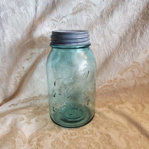 May include: A vintage blue glass Ball Perfect Mason jar with a silver lid.