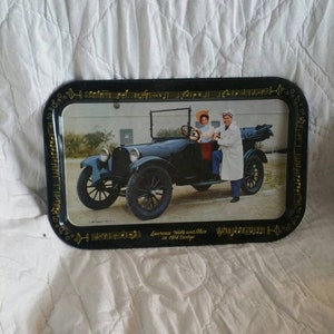 May include: A black metal serving tray with a vintage image of Lawrence Welk and Alice in a 1914 Dodge. The tray is decorated with musical notes and a martini glass design.