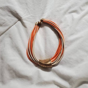 Kenny Hwang, K H Studios, 14 inch Beige and Orange Multi-Strand Cord, Choker Necklace, Designer Necklace with Gold Toned Hoop Center