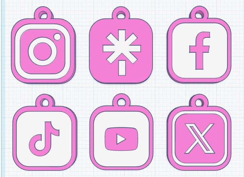 May include: Six pink and white social media logo charms, including Instagram, a stylized asterisk, Facebook, TikTok, YouTube, and X. Each charm has a loop for hanging and a white border.
