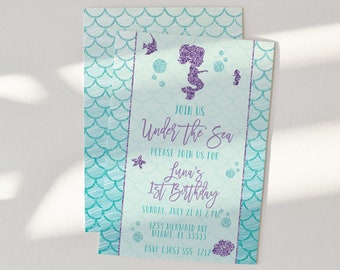 May include: A rectangular invitation card featuring a teal and white mermaid scale pattern background. The center panel displays purple glitter graphics of a mermaid, bubbles, and sea life, with text reading Join Us Under the Sea for Luna's 1st Birthday.