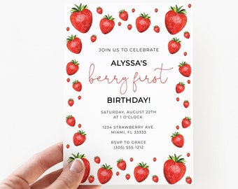 May include: A white rectangular birthday invitation card featuring a border of red strawberries. The text reads: JOIN US TO CELEBRATE ALYSSA'S berry first BIRTHDAY! SATURDAY, AUGUST 22TH AT 1 O'CLOCK 1234 STRAWBERRY AVE. MIAMI, FL 33333 RSVP TO GRACE (305) 555-1212.