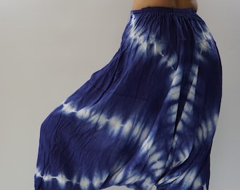 May include: Blue and white tie-dye pants with a loose, flowing fit. The pants have a wide, elastic waistband and a relaxed, comfortable style.