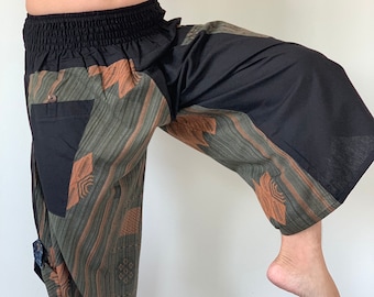 May include: Black and green patterned pants with a wide leg and elastic waistband. The pants have a brown and green geometric design.