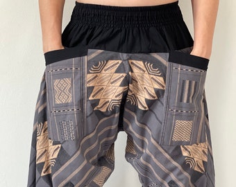 May include: Gray and beige patterned pants with a black elastic waistband and side pockets. The pants have a loose, flowing fit.
