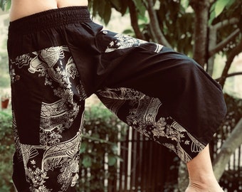 May include: Black and white patterned pants with a wide leg and an elastic waistband. The pants have a traditional Asian design with a floral and wave pattern.