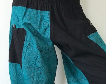 May include: Black and teal blue patterned pants with a wide elastic waistband. The pants have a loose, flowing fit and are made of a lightweight fabric.
