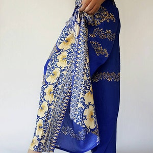 May include: Blue and cream patterned trousers with a wide leg and a tie at the waist.