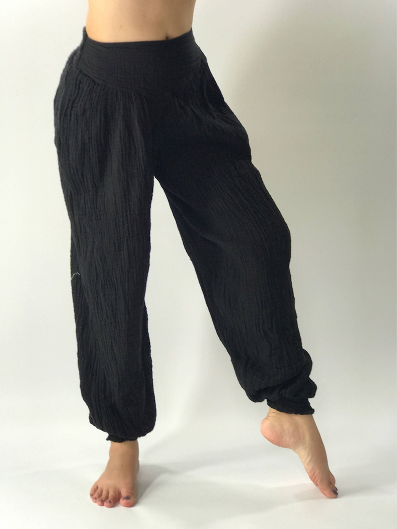 May include: Black cotton pants with a wide leg and elastic waistband.