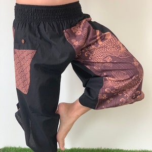 May include: Black and brown patterned pants with an elastic waistband. The pants have a large pocket on the left leg with a geometric pattern.