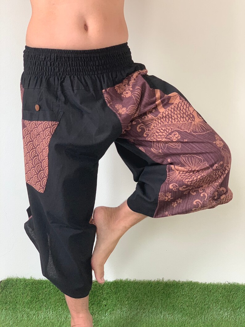 May include: Black and brown patterned pants with an elastic waistband. The pants have a large pocket on the left leg with a geometric pattern.