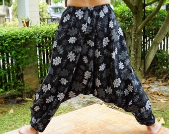 May include: Black and gray patterned pants with a loose, wide-leg style. The pants have a drawstring waist and a relaxed fit.