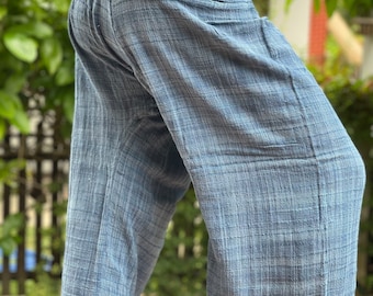 May include: A pair of blue cotton pants with a wide waistband and a loose fit. The pants have a subtle checkered pattern.