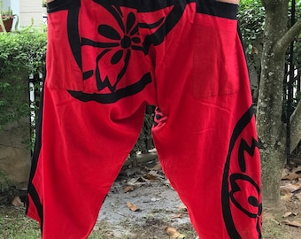 May include: Red and black patterned pants with a wide leg and elastic waistband. The pants have a floral design and a black waistband.