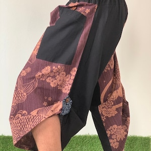 May include: Brown and black patterned pants with a black pocket and elastic waistband.