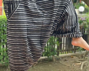 May include: Black and white striped pants with a wide leg and a drawstring waist.
