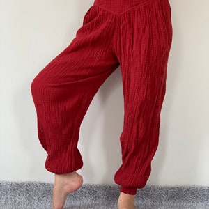 May include: Red cotton pants with a wide leg and elastic waistband.