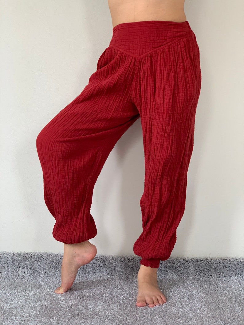 May include: Red cotton pants with a wide leg and elastic waistband.