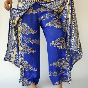 May include: Blue and gold patterned trousers with a wrap-around skirt. The skirt has a white and gold floral design.