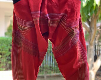 May include: Red, striped, loose-fitting pants with a black elastic waistband and side pockets.
