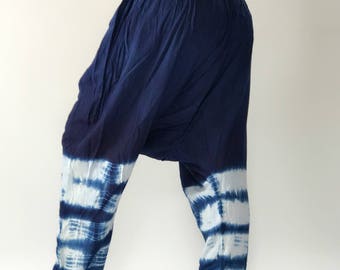 May include: Blue and white tie-dye pants with a loose, flowing fit. The pants have a wide, elastic waistband and a relaxed, comfortable style.