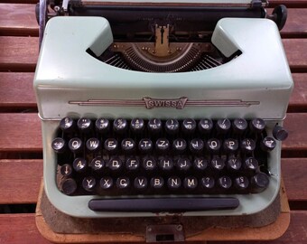 Swissa Junior typewriter 1960's with English keyboard in baby blue colour