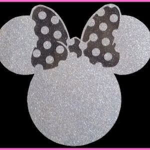 May include: A silver glitter Minnie Mouse head silhouette with a black polka dot bow.