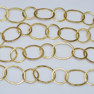 May include: Gold chain with oval links. The chain is made of metal and has a textured finish.