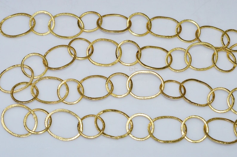 May include: Gold chain with oval links. The chain is made of metal and has a textured finish.