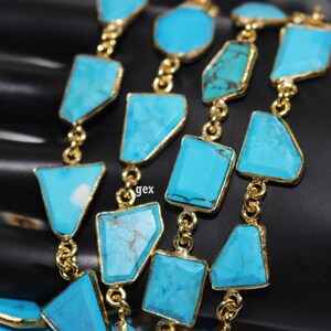 May include: A gold chain with turquoise gemstone beads. The beads are various shapes and sizes, including squares, rectangles, and triangles.