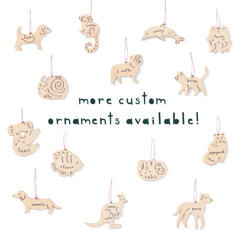 May include: A collection of wooden ornaments featuring various animal shapes, each with a personalized name. The ornaments are painted in natural wood tones and have a rustic charm. The text "more custom ornaments available!" is displayed in green letters.