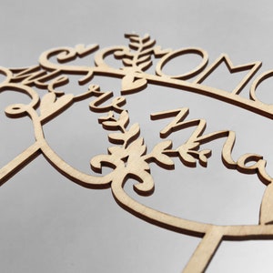 May include: Wooden cake topper with the words "Mr & Mrs" and a floral design.
