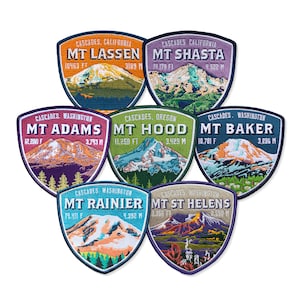 May include: Seven colorful embroidered patches featuring different mountains in the Cascade Range. Each patch has the mountain's name, location, and elevation in both feet and meters. The patches are arranged in a circle.