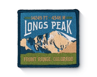May include: A blue and green embroidered patch with the text "Longs Peak" and "Front Range, Colorado". The patch also features a mountain range with snow on the peak. The text "14249 FT - 4346 M" is above the text "Longs Peak".