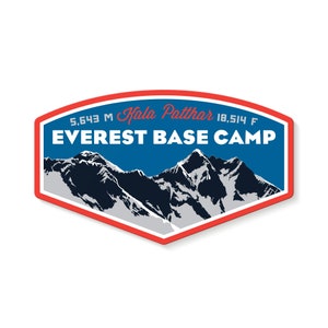 May include: A blue and red sticker featuring a mountain range illustration and the text "Everest Base Camp" in white. The text "Kala Patthar" is written in cursive above the mountain range. The sticker also includes the text "5,643 M" and "18,514 F".
