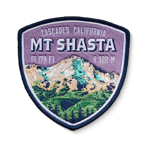 May include: Purple and blue embroidered patch with a mountain scene and the text "CASCADES CALIFORNIA MT SHASTA 14,179 FT 4,322 M".