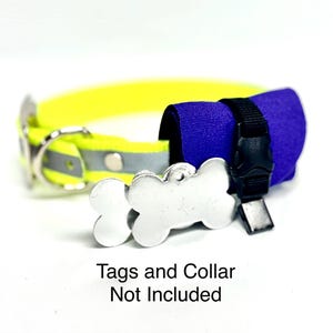 May include: A neon yellow pet collar featuring a reflective silver strip, a silver metal D-ring, and a silver bone-shaped tag. Attached is a purple fabric accessory secured with a black plastic buckle. Text reads: Tags and Collar Not Included.