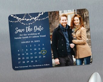 May include: Save the Date magnet with a blue background and white string lights. The magnet features a photo of a couple and a calendar with August 19, 2023 circled. The text reads "Save the Date for the wedding of Natalie Smith & Callum Wood August 19, 2023 Port Townsend, WA | Invitations to Follow www.NEWANDBLUE.com"