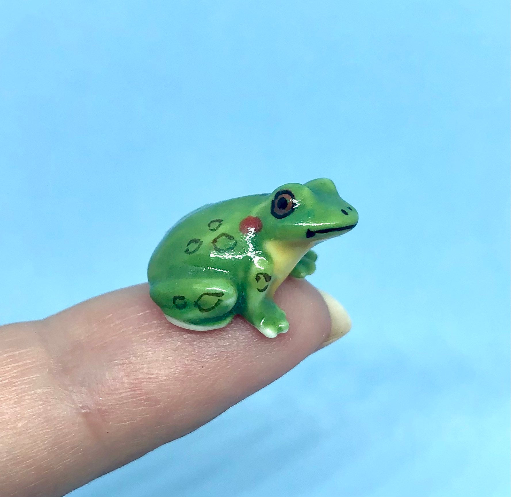 Miniature ceramic green frog with yellow belly
