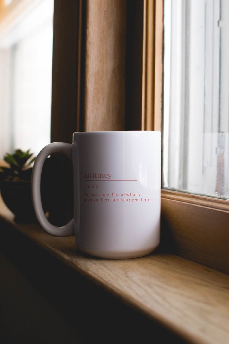 11oz white mug with a customizable definition design in pink. Add a name and the definition for that person.