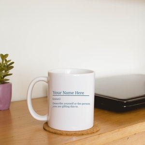 11oz white mug with a customizable definition design in blue. Add a name and the definition for that person.