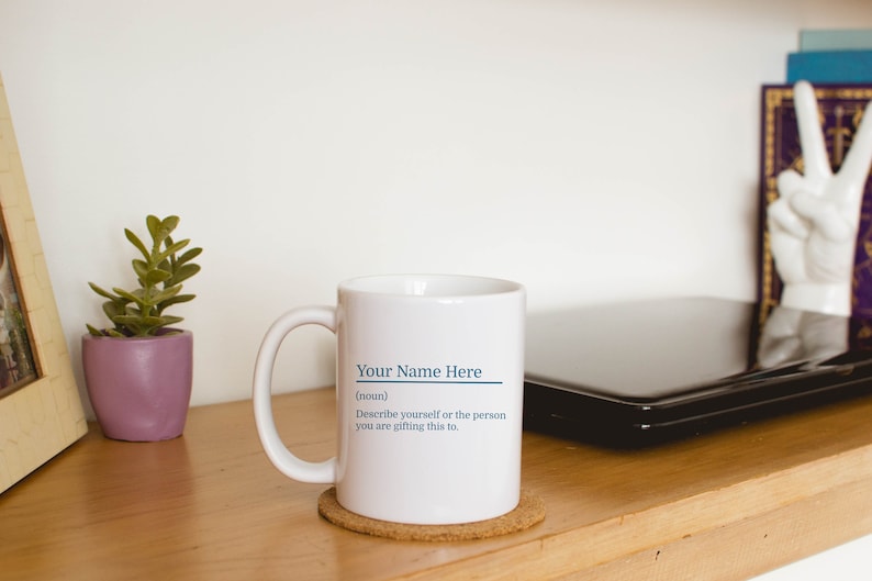 11oz white mug with a customizable definition design in blue. Add a name and the definition for that person.