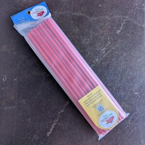 May include: A package of red plastic rods for a quilting frame system, enclosed in a clear plastic sleeve with a blue header card labeled "Red Snapper" and a yellow instruction label featuring a QR code and the product name "Red Snapper".