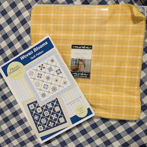 May include: A quilt pattern titled "Woven Blooms" by Pieces of Treasure, next to a yellow plaid fabric. The pattern shows a floral quilt design in blue, tan, and white. The fabric is a yellow and white plaid. The finished size is 68" x 68".