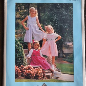 May include: A pattern packet featuring three young girls modeling dresses, culottes, and a blouse. The packet has a blue border and includes the text "Culotte, Jumper, & Blouse." The packet also includes the text "Chery Williams Patterns."