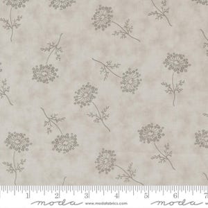 May include: A beige fabric with a repeating pattern of stylized dandelion flowers in a muted brown color. The flowers are on slender stems with small leaves. The fabric has a subtle, textured appearance.