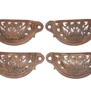 May include: Set of four antique cast iron drawer pulls with intricate floral designs. The pulls are a dark brown color and have a distressed finish.