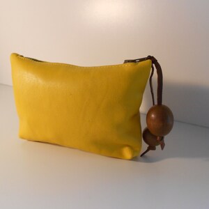 Small leather handcrafted purse with wooden bead pull