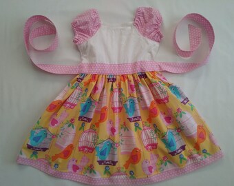 Girls dress with colorful birds and eyelet embroidery fabric for the bodice.Only this 1 available. Handmade. NEW.